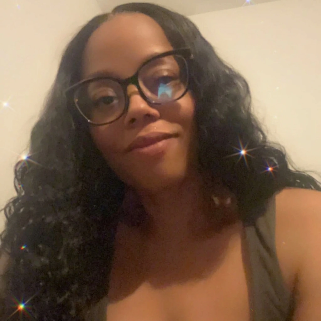 Cherise Franklin wearing glasses with long, dark waves